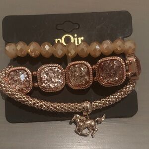 nOir Jewelry Sparkling Gold and Cream Bracelet Trio with horse charm